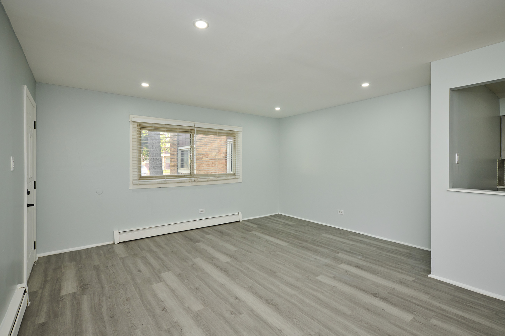 1320 Lore Lane, Unit 101A Lombard, IL 60148 - Photo 27 of 65 a view of a room with wooden floor and window
