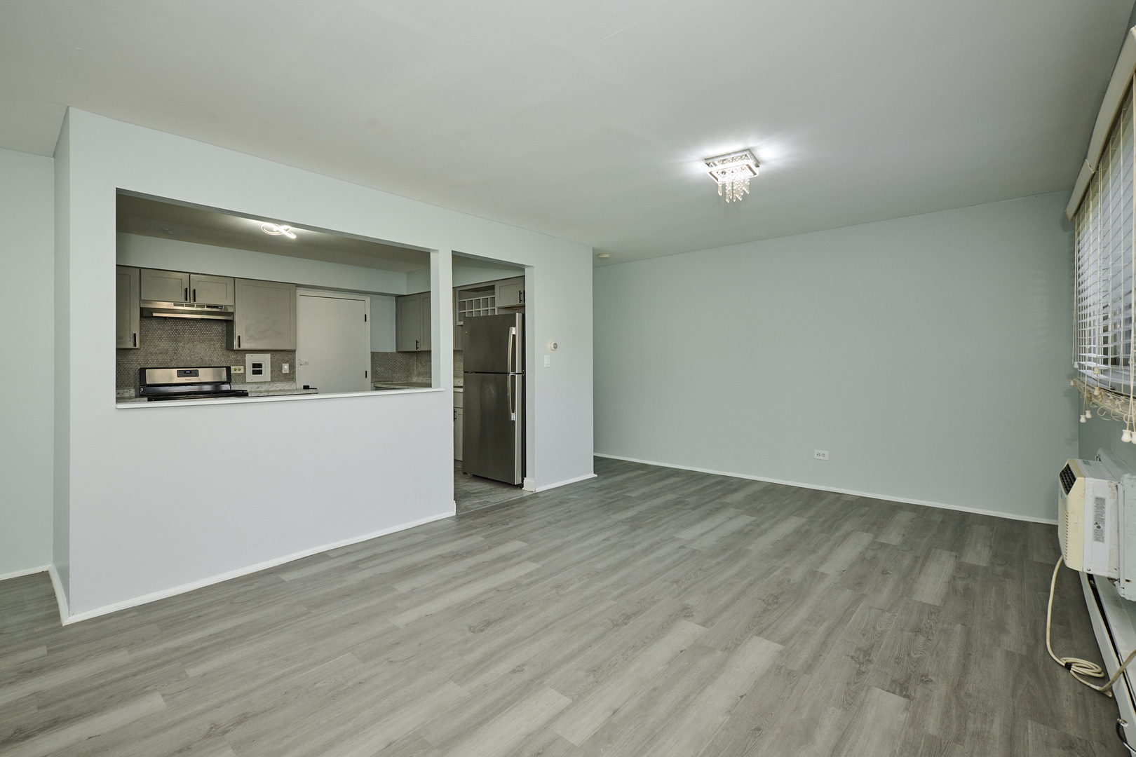 1320 Lore Lane, Unit 101A Lombard, IL 60148 - Photo 28 of 65 a view of a kitchen with a sink and a refrigerator