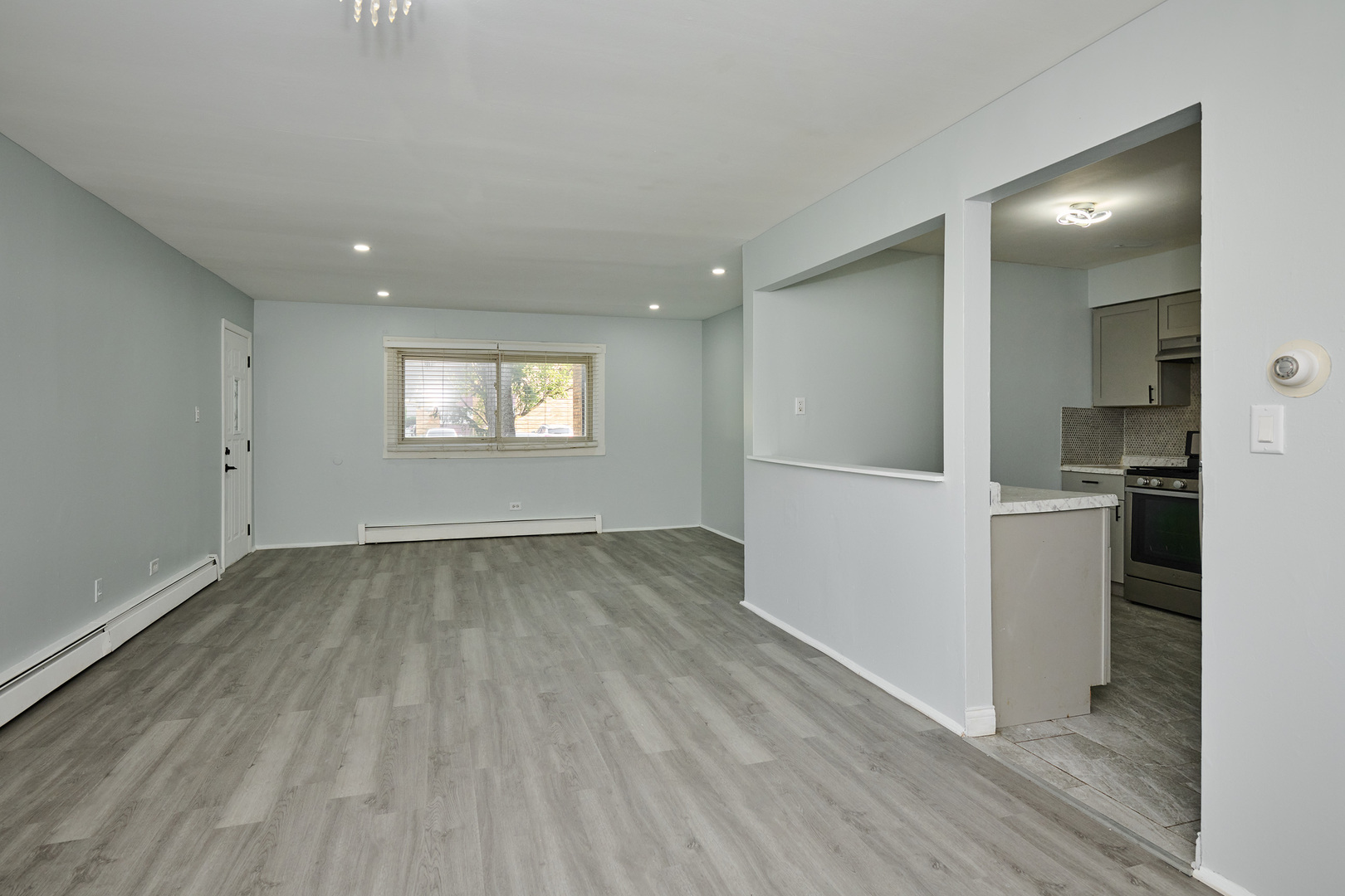1320 Lore Lane, Unit 101A Lombard, IL 60148 - Photo 29 of 65 an empty room with wooden floor and a window