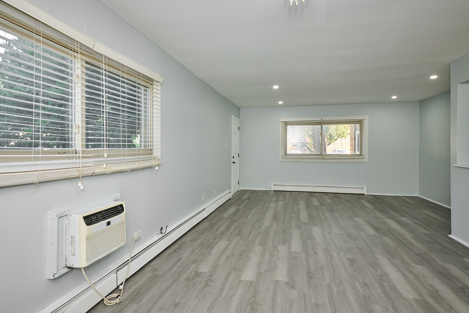 1320 Lore Lane, Unit 101A Lombard, IL 60148 - Photo 30 of 65 an empty room with wooden floor and windows