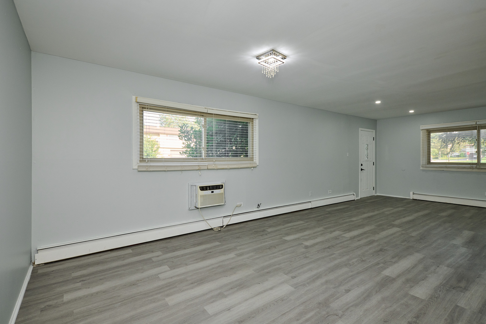 1320 Lore Lane, Unit 101A Lombard, IL 60148 - Photo 31 of 65 an empty room with wooden floor and windows