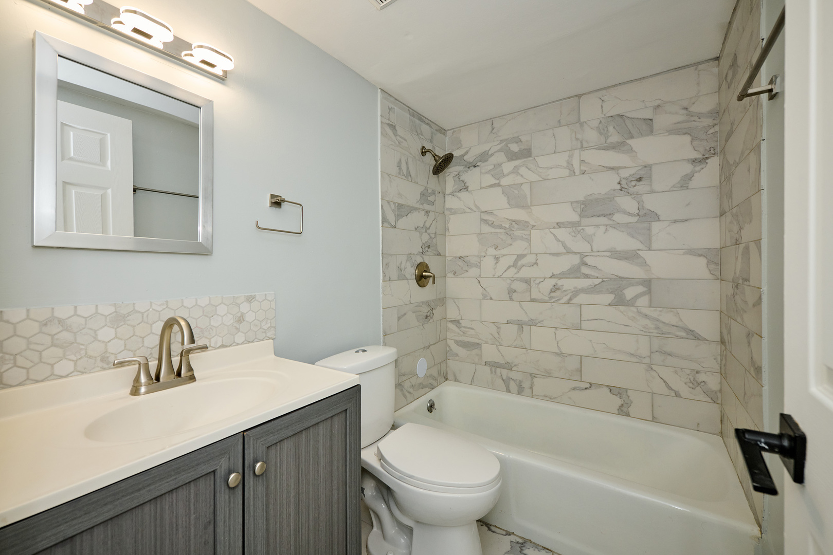 1320 Lore Lane, Unit 101A Lombard, IL 60148 - Photo 34 of 65 a bathroom with a sink a toilet and shower