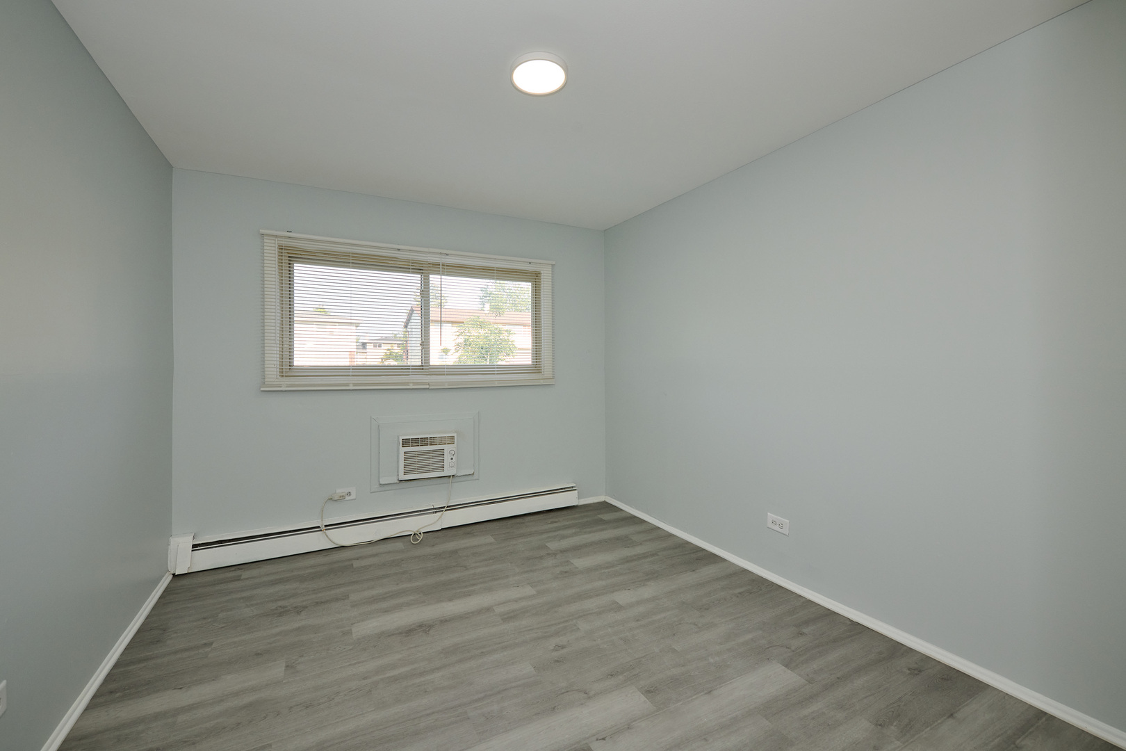 1320 Lore Lane, Unit 101A Lombard, IL 60148 - Photo 37 of 65 an empty room with wooden floor and windows
