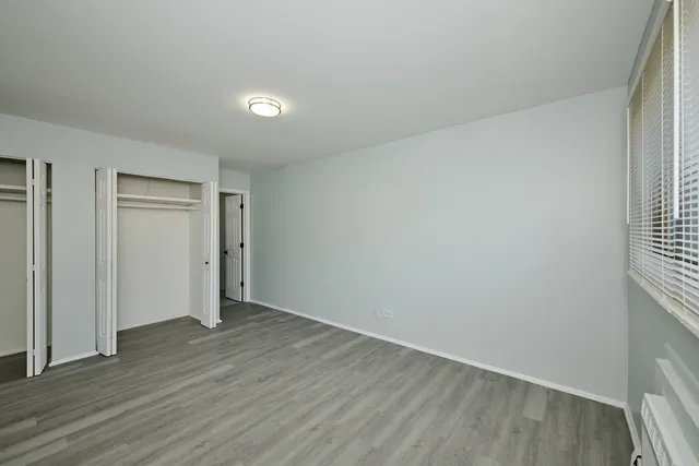 a bathroom with a toilet sink vanity and mirror