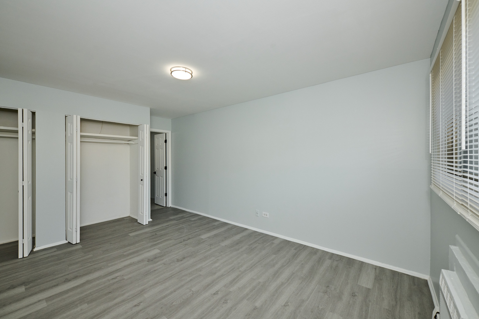 1320 Lore Lane, Unit 101A Lombard, IL 60148 - Photo 41 of 65 a view of an empty room with wooden floor and a window