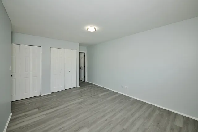 a bathroom with a toilet sink vanity and mirror