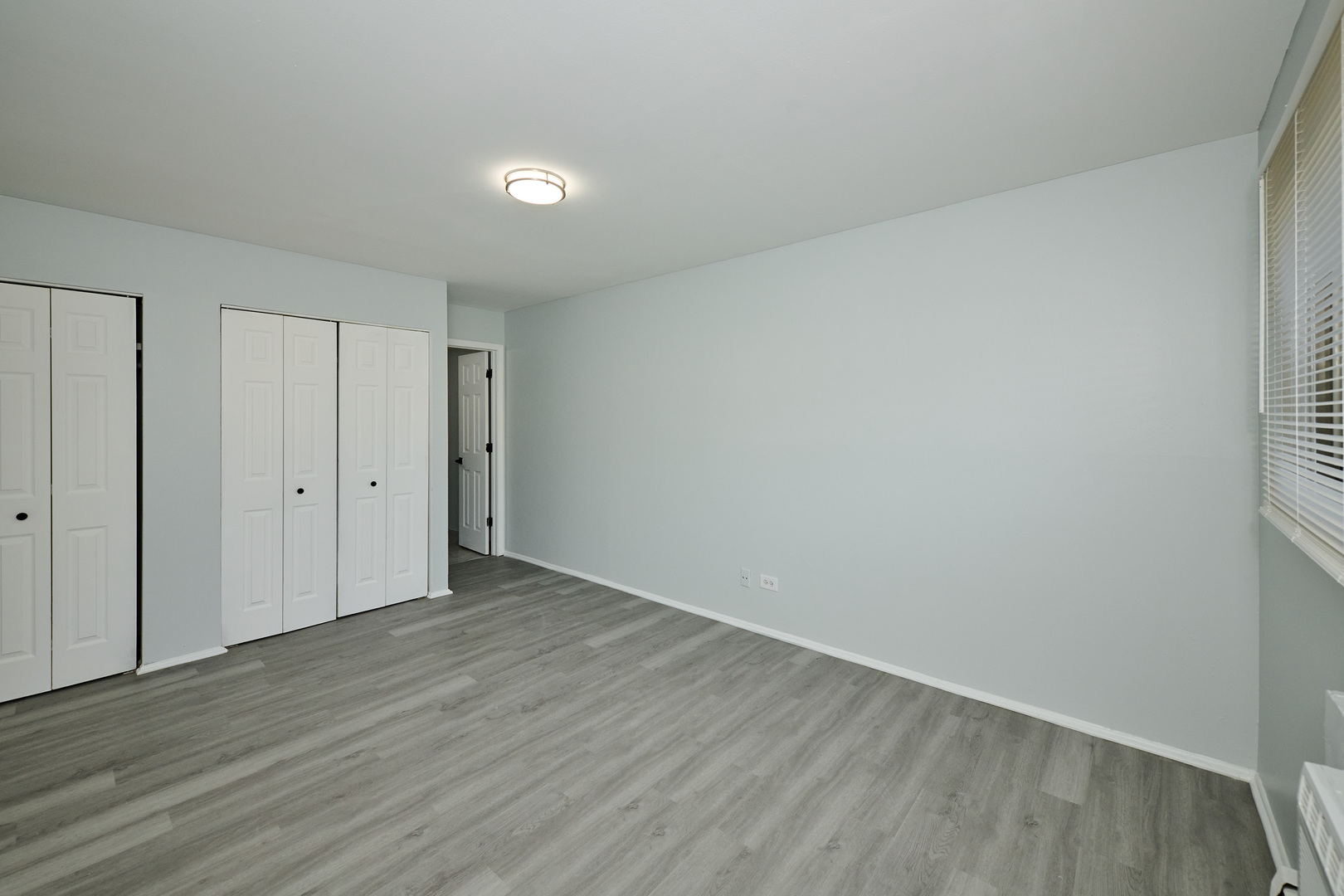 1320 Lore Lane, Unit 101A Lombard, IL 60148 - Photo 43 of 65 a view of an empty room with wooden floor