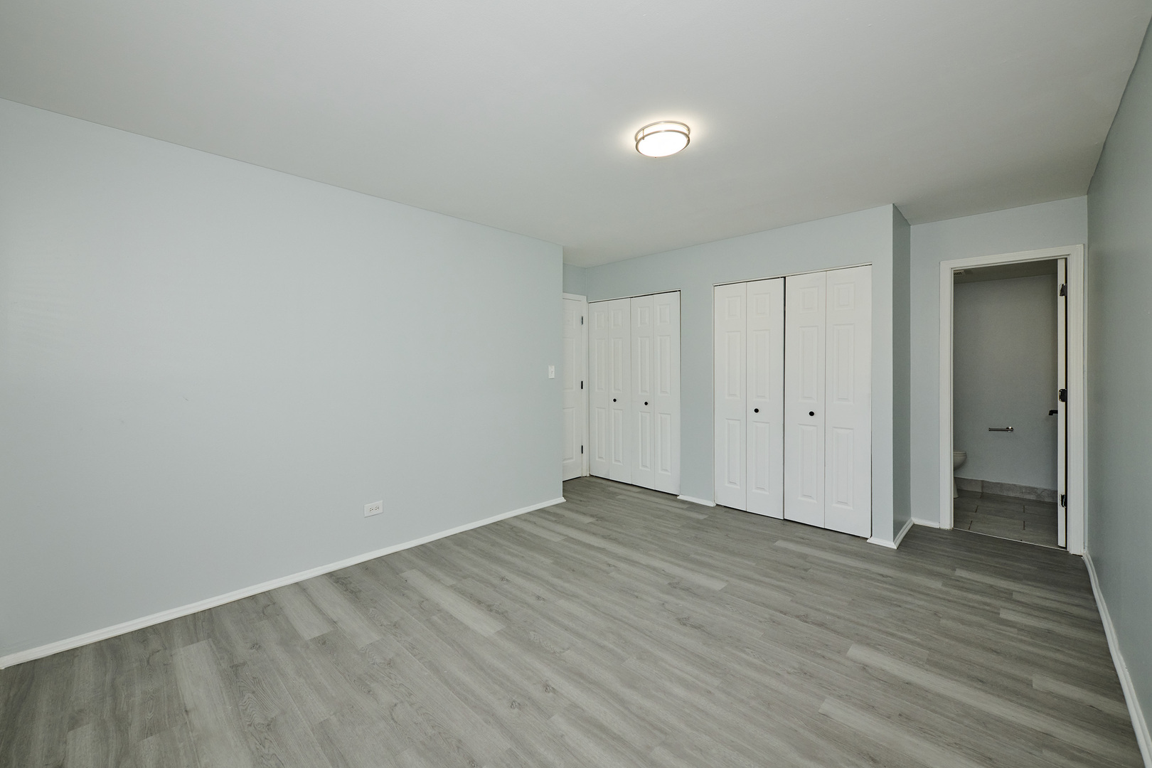 1320 Lore Lane, Unit 101A Lombard, IL 60148 - Photo 44 of 65 a view of an empty room and wooden floor