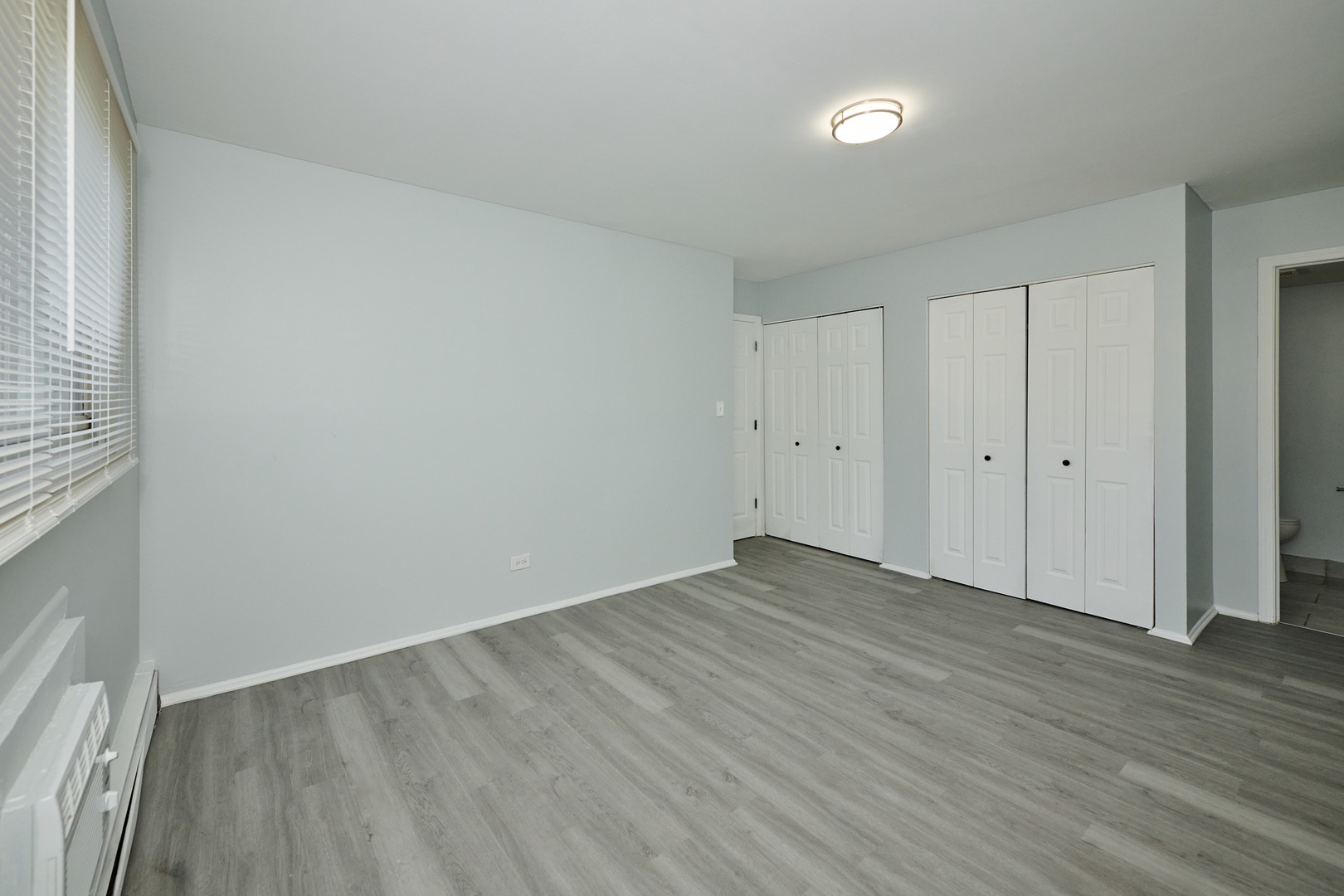 1320 Lore Lane, Unit 101A Lombard, IL 60148 - Photo 45 of 65 a view of an empty room with wooden floor