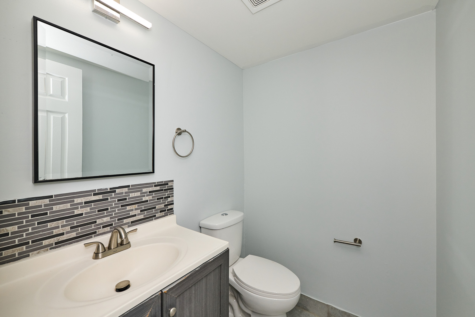 1320 Lore Lane, Unit 101A Lombard, IL 60148 - Photo 50 of 65 a bathroom with a sink mirror vanity and toilet