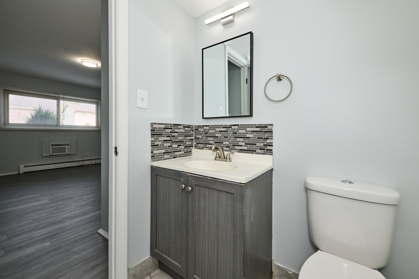1320 Lore Lane, Unit 101A Lombard, IL 60148 - Photo 51 of 65 a bathroom with a sink a toilet and mirror