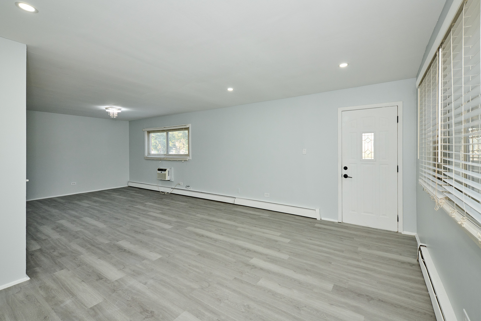 1320 Lore Lane, Unit 101A Lombard, IL 60148 - Photo 6 of 65 an empty room with wooden floor and windows