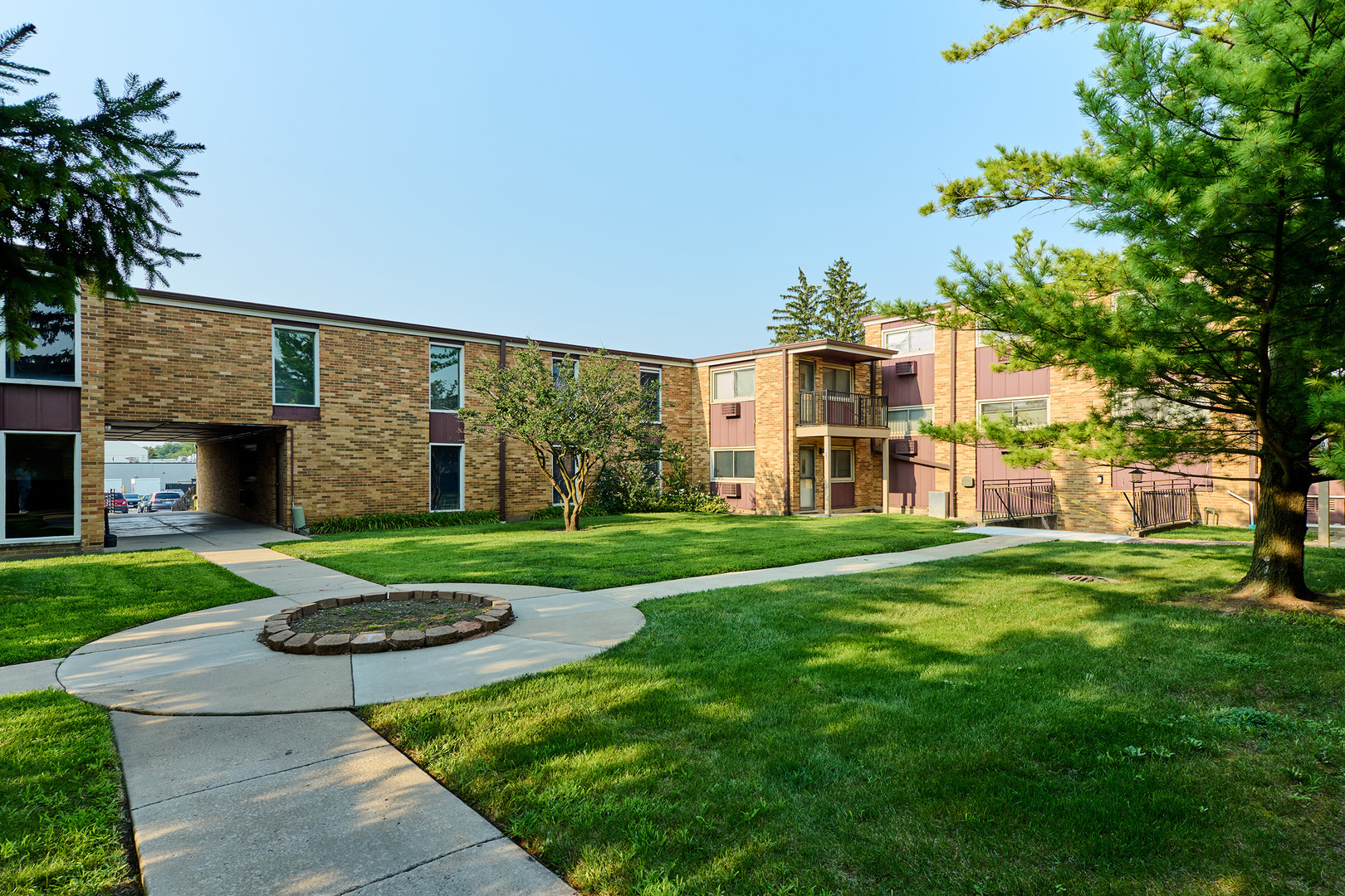 1320 Lore Lane, Unit 101A Lombard, IL 60148 - Photo 62 of 65 a front view of a house with a yard table and chairs