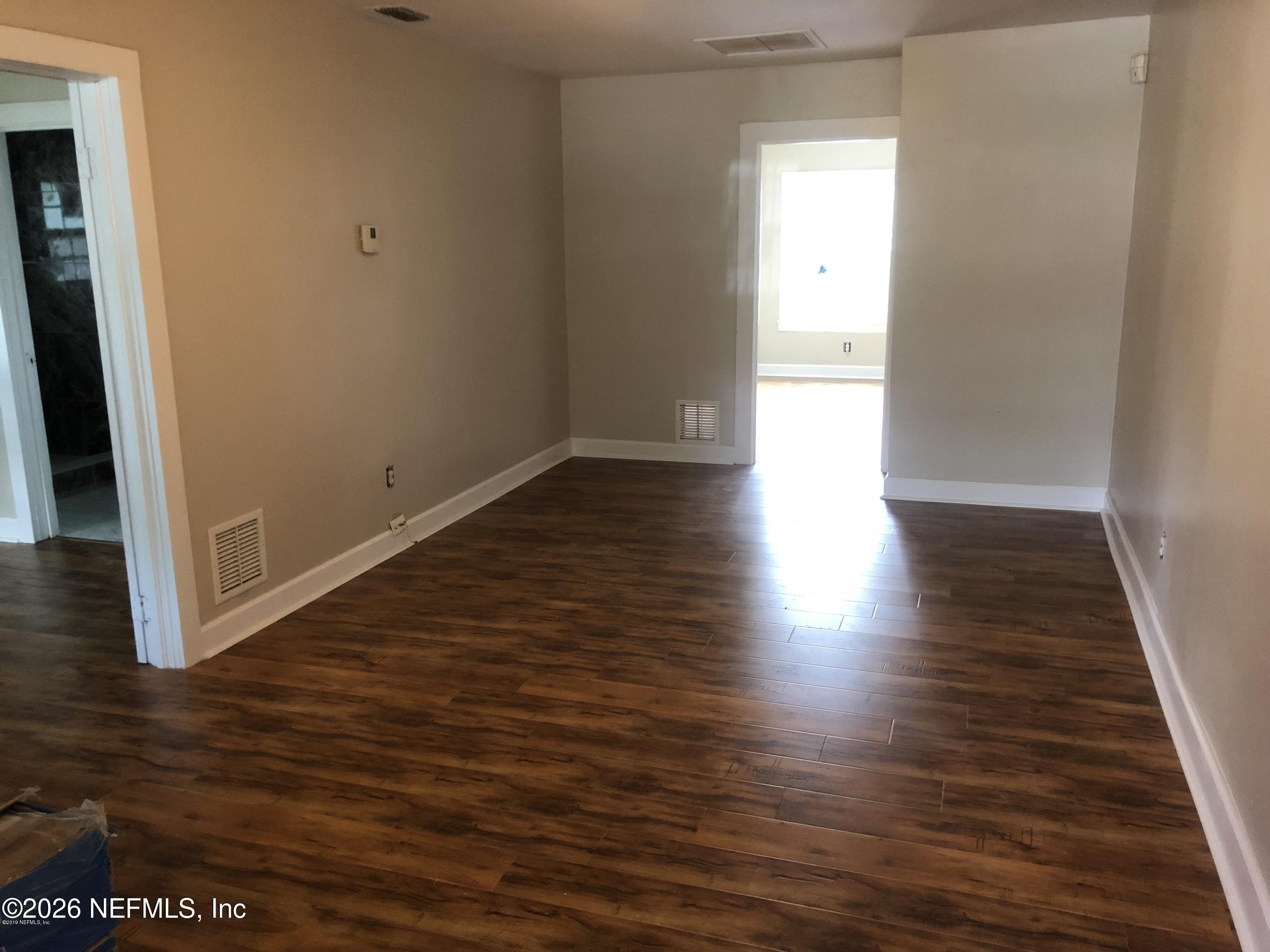 925 Phillips Street, Unit 3 Jacksonville, FL 32207 - Photo 5 of 10 a view of an empty room with wooden floor and a window