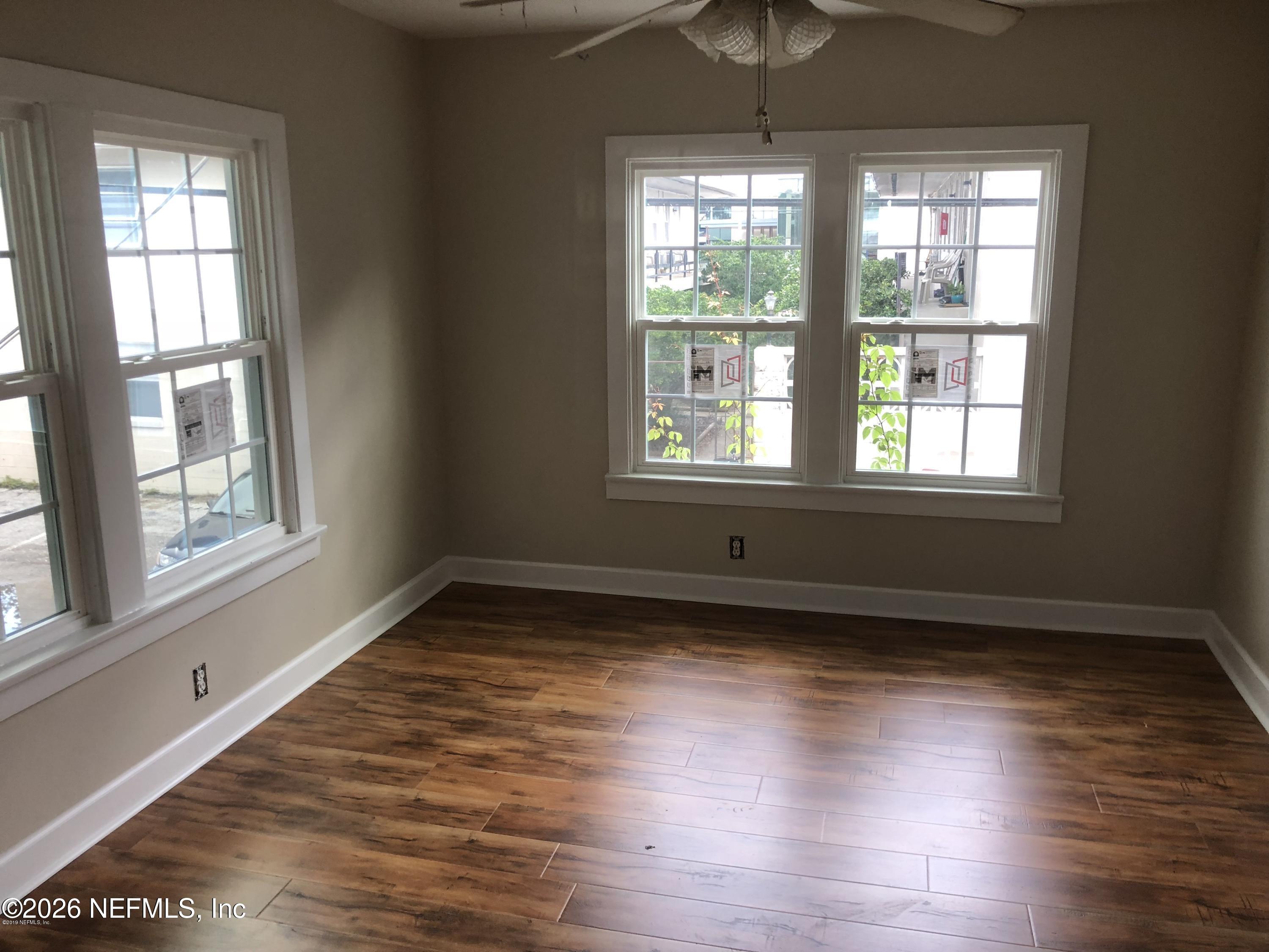 925 Phillips Street, Unit 3 Jacksonville, FL 32207 - Photo 6 of 10 a view of an empty room with wooden floor and a window
