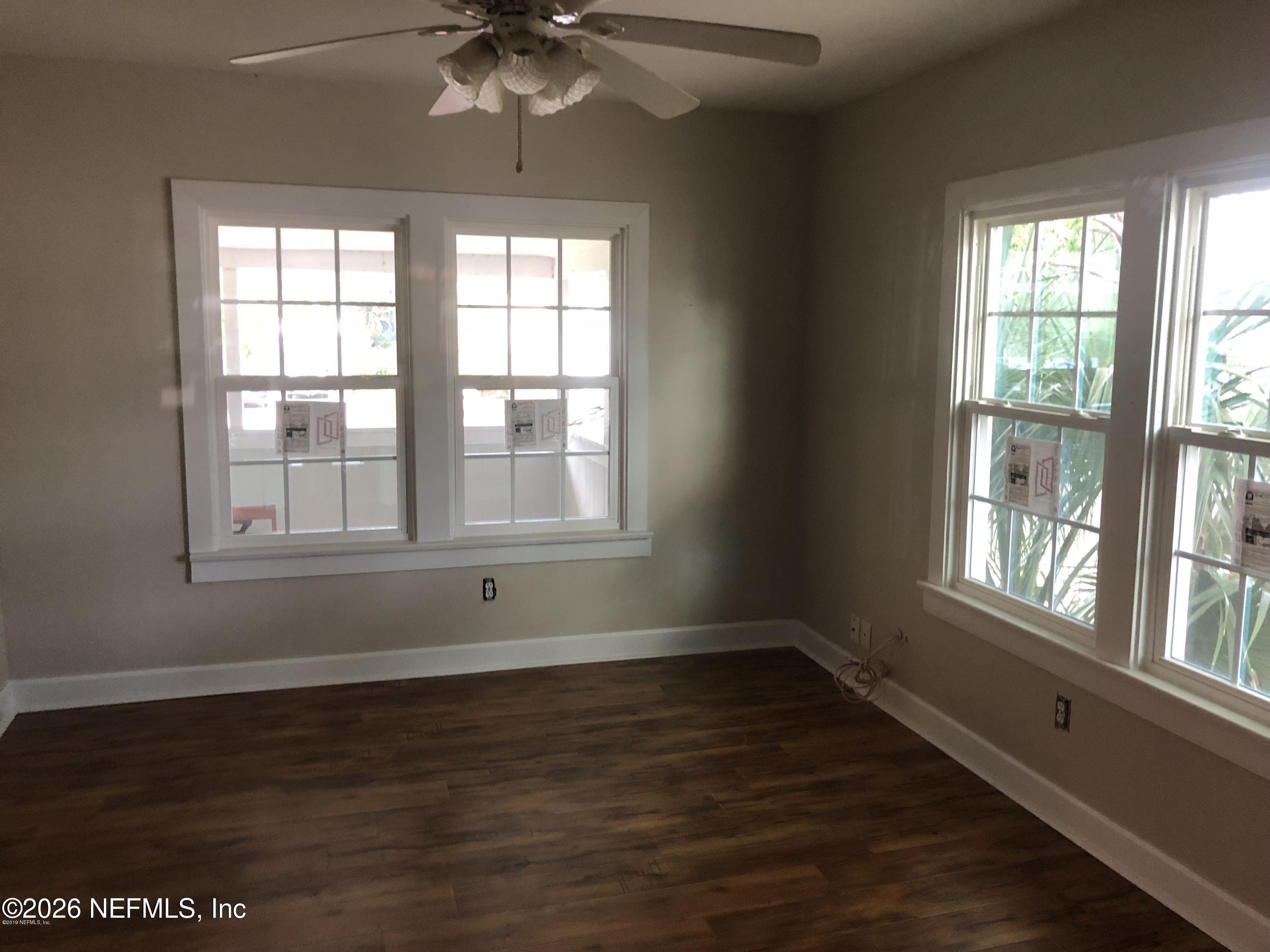 925 Phillips Street, Unit 3 Jacksonville, FL 32207 - Photo 7 of 10 a view of an empty room with wooden floor and a window