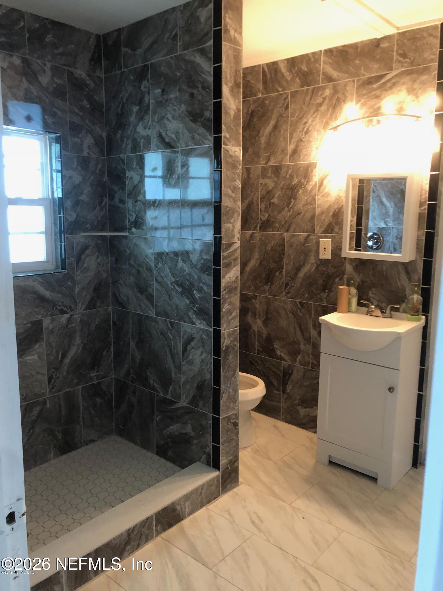 925 Phillips Street, Unit 3 Jacksonville, FL 32207 - Photo 8 of 10 a bathroom with a toilet and a shower