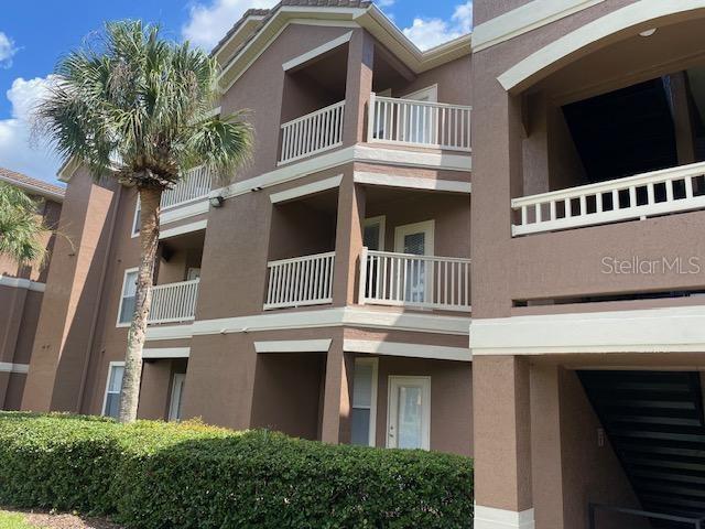 8849 Villa View Circle, Unit 203 Orlando, FL 32821 - Photo 12 of 20 a front view of a house with a tree