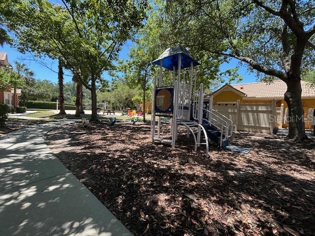 8849 Villa View Circle, Unit 203 Orlando, FL 32821 - Photo 16 of 20 a front view of a house with garden