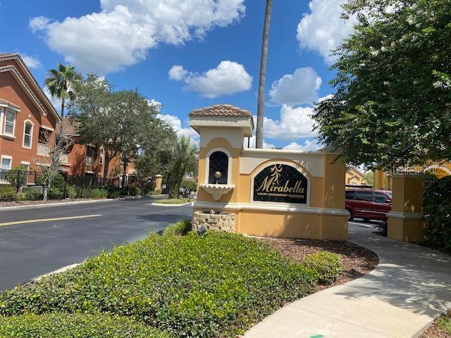 8849 Villa View Circle, Unit 203 Orlando, FL 32821 - Photo 2 of 20 a front view of a house with a garden