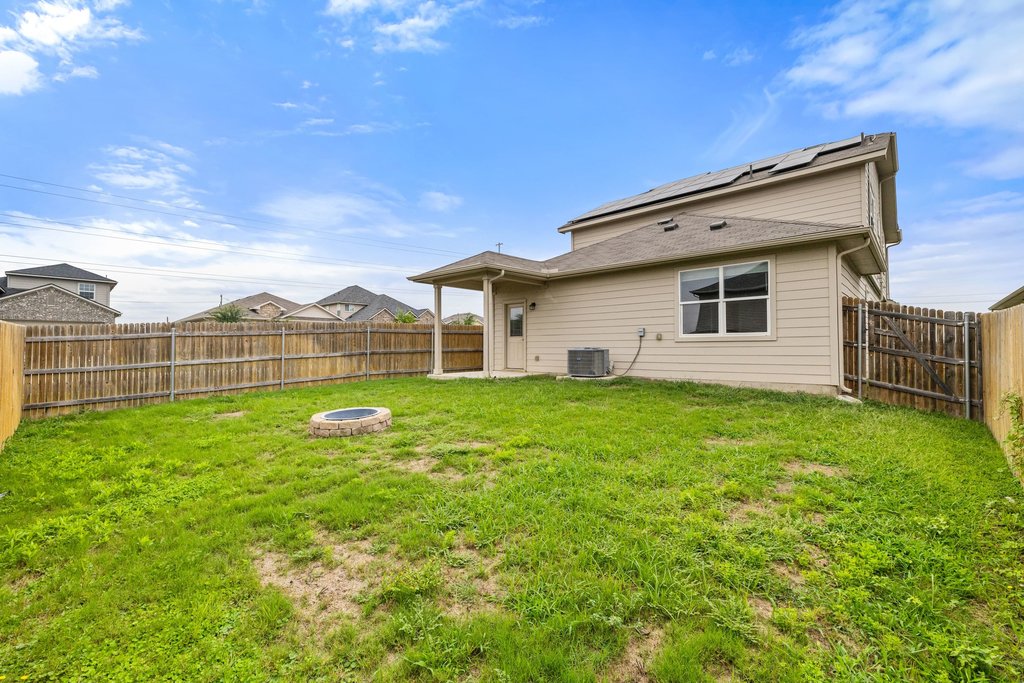 102 Ashford Way Georgetown, TX 78626 - Photo 28 of 28 A spacious, fenced backyard with a patio and a dedicated fire pit for outdoor enjoyment.