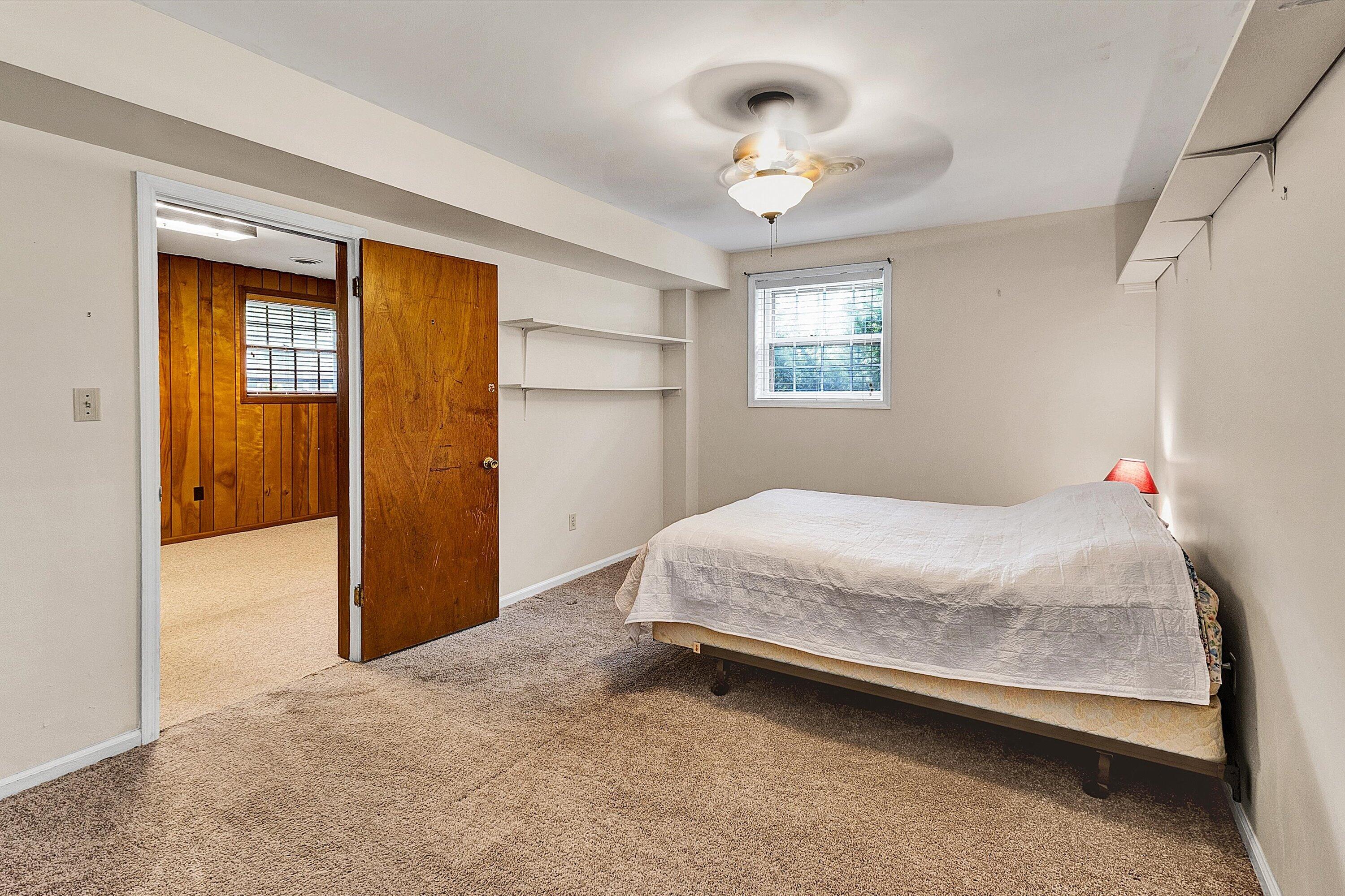 912 Cherokee Trail Covington, VA 24426 - Photo 22 of 31 a bedroom with a bed and a chandelier