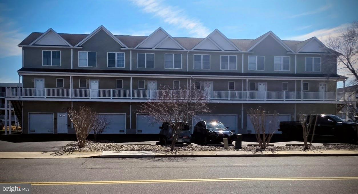 617 Salt Spray Road, Unit B Ocean City, MD 21842 - Photo 14 of 72 a front view of a house with a garden and plants