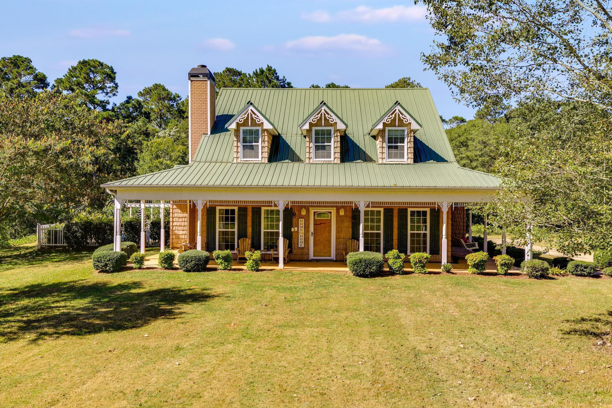 5411 Post Road Winston, GA 30187 - Photo 1 of 1 a front view of a building with a garden and plants