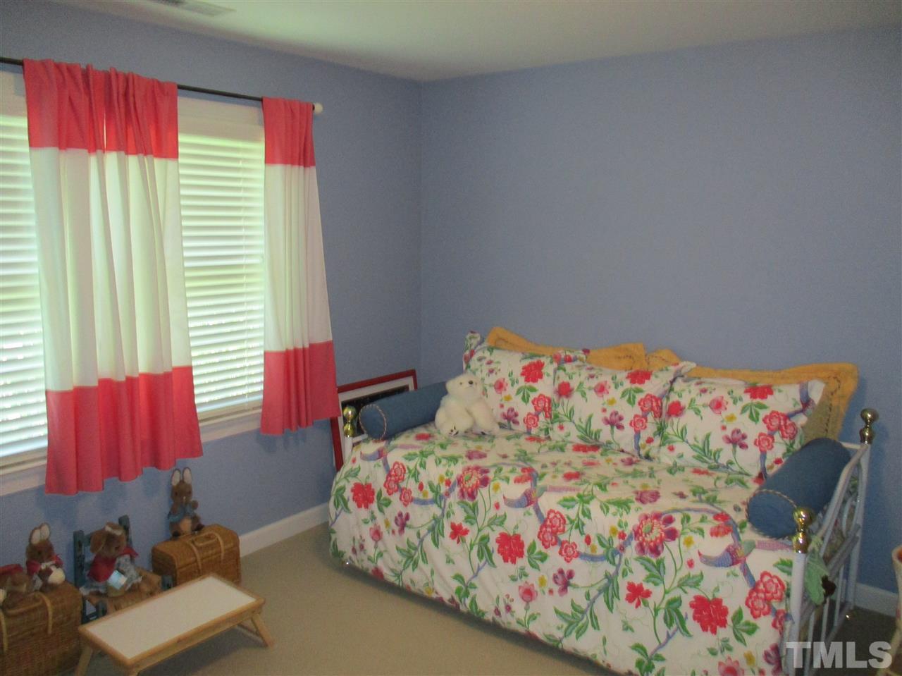 2513 Wertherson Lane Raleigh, NC 27613 - Photo 14 of 25 a bedroom with a bed and a window