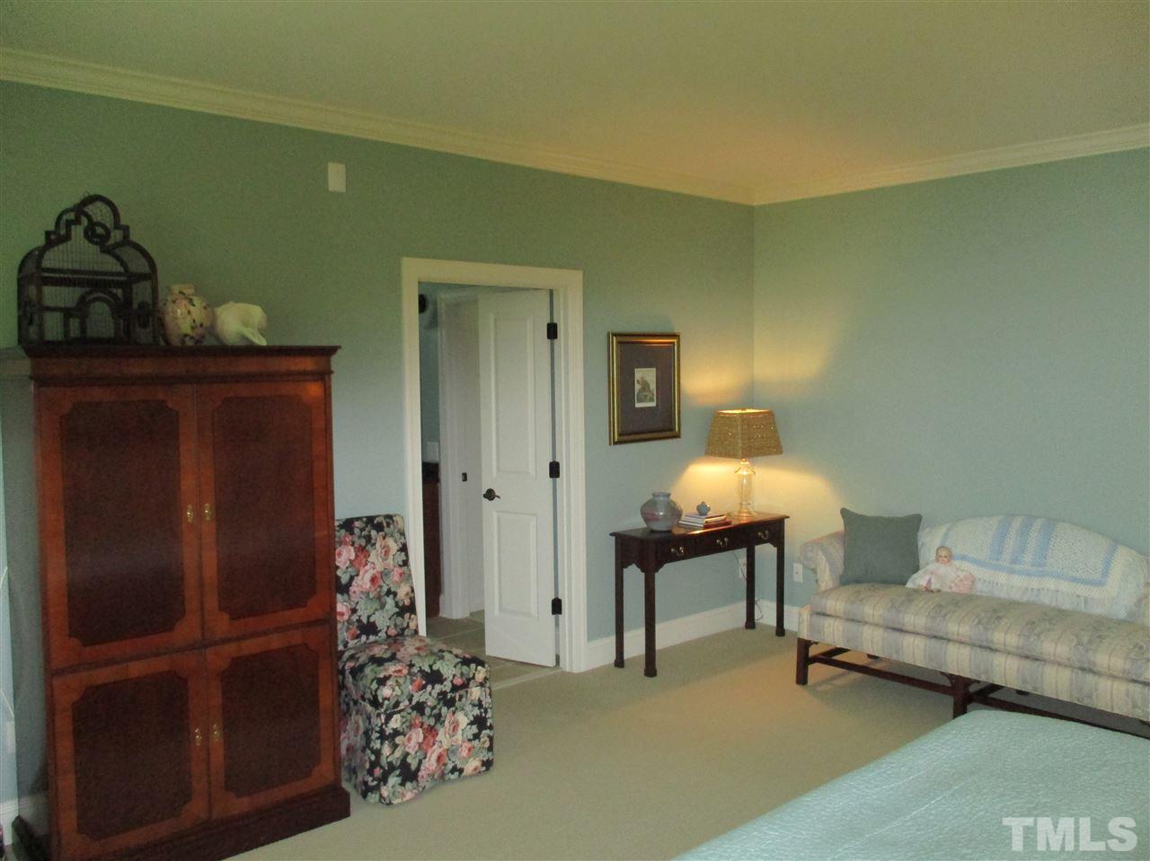 2513 Wertherson Lane Raleigh, NC 27613 - Photo 21 of 25 a bedroom with a bed and a chair