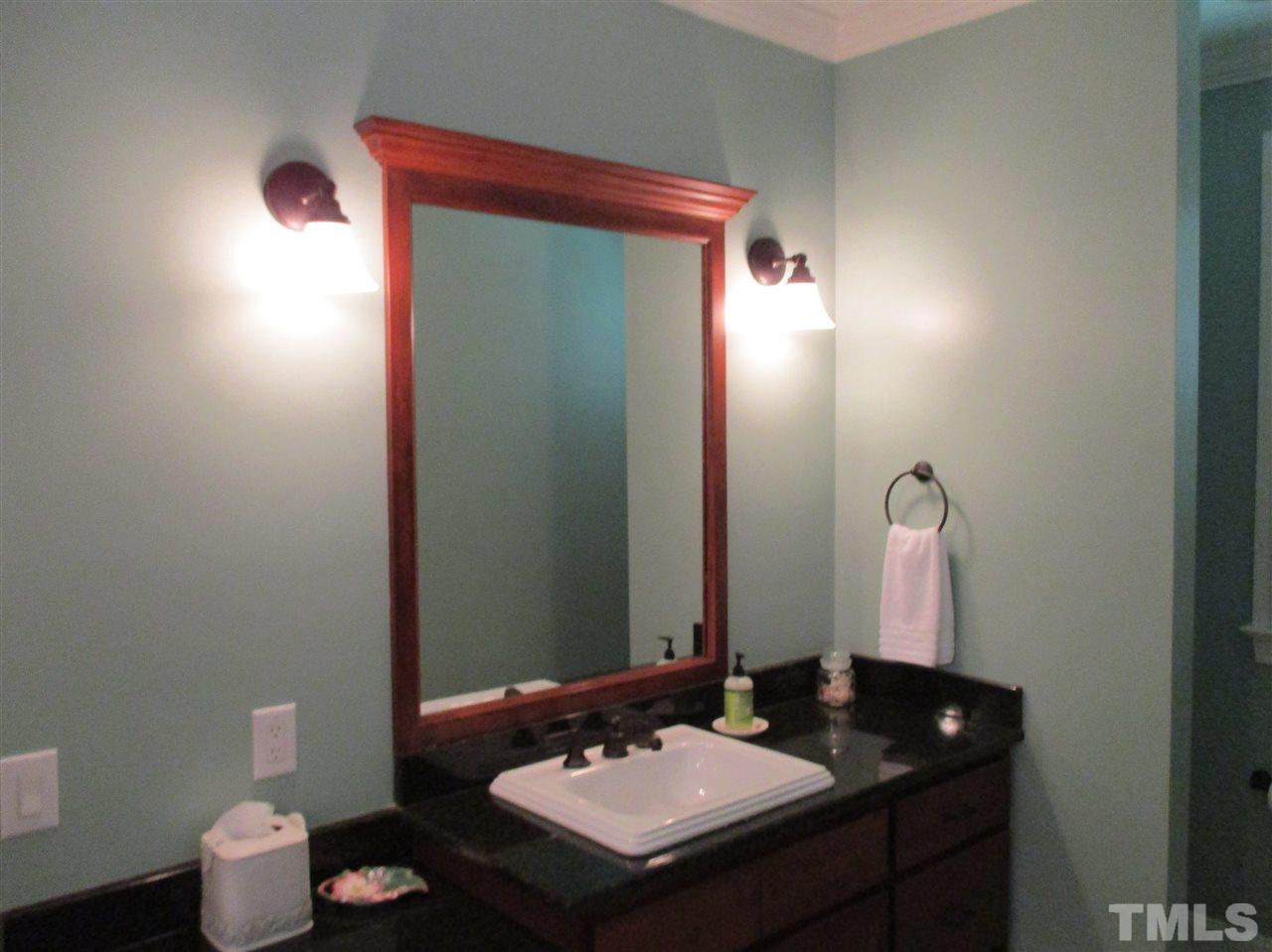 2513 Wertherson Lane Raleigh, NC 27613 - Photo 23 of 25 a bathroom with a sink and a mirror
