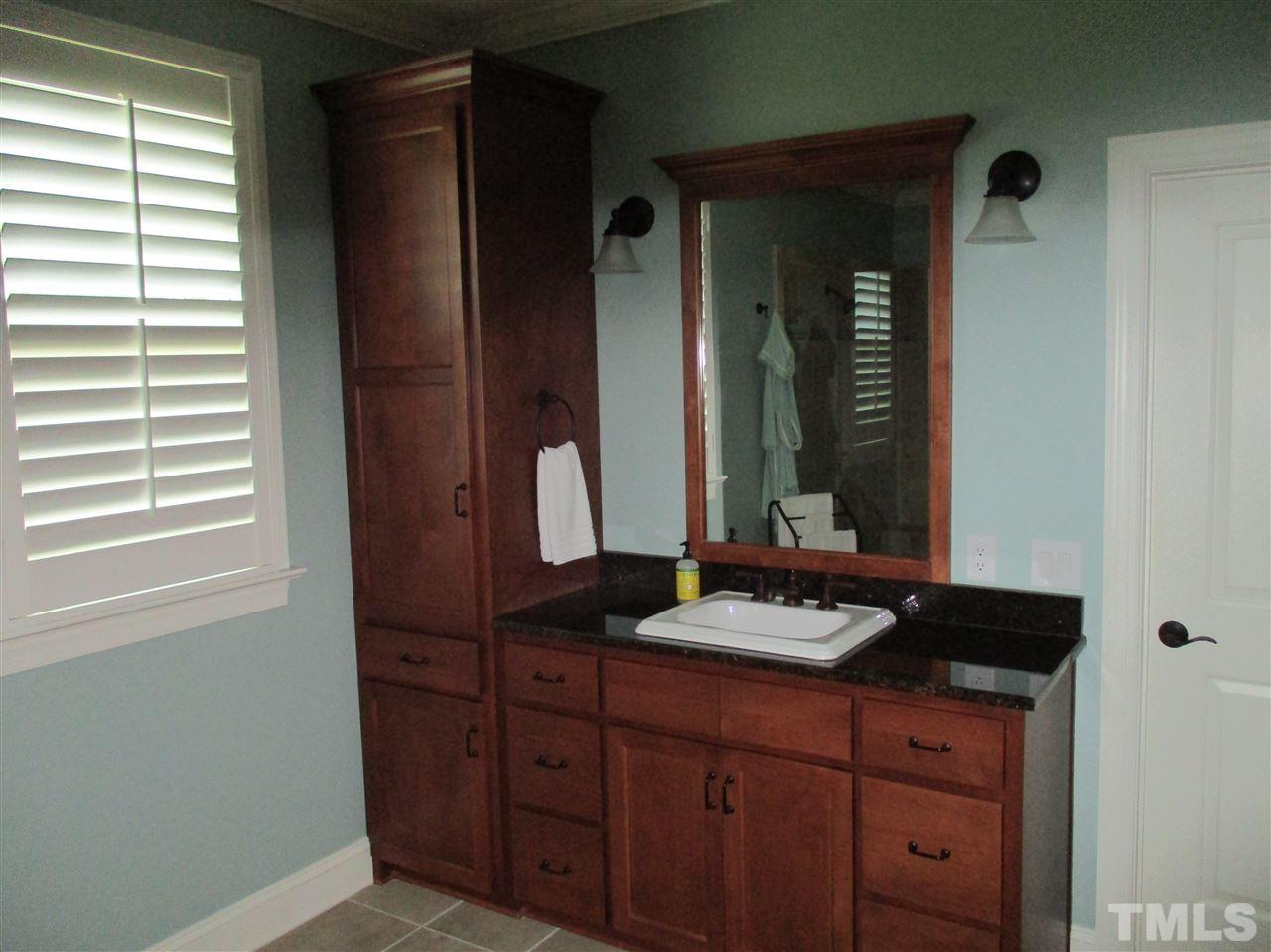 2513 Wertherson Lane Raleigh, NC 27613 - Photo 24 of 25 a bathroom with a granite countertop sink and a mirror