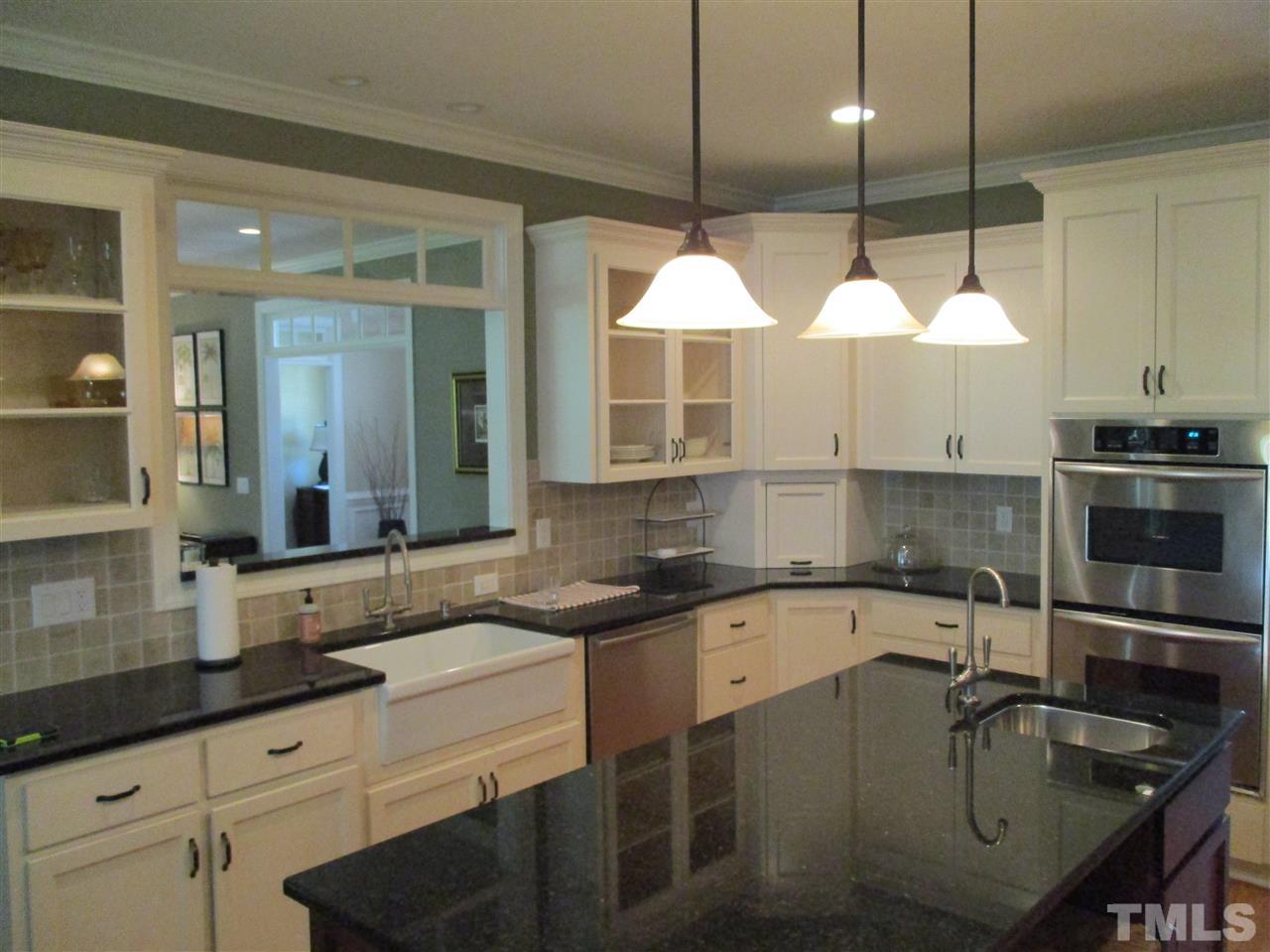 2513 Wertherson Lane Raleigh, NC 27613 - Photo 6 of 25 a kitchen with a sink a counter and cabinets