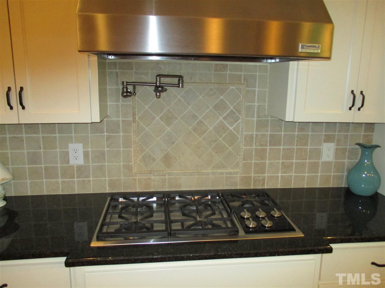 2513 Wertherson Lane Raleigh, NC 27613 - Photo 8 of 25 a close view of sink a stove and a mirror