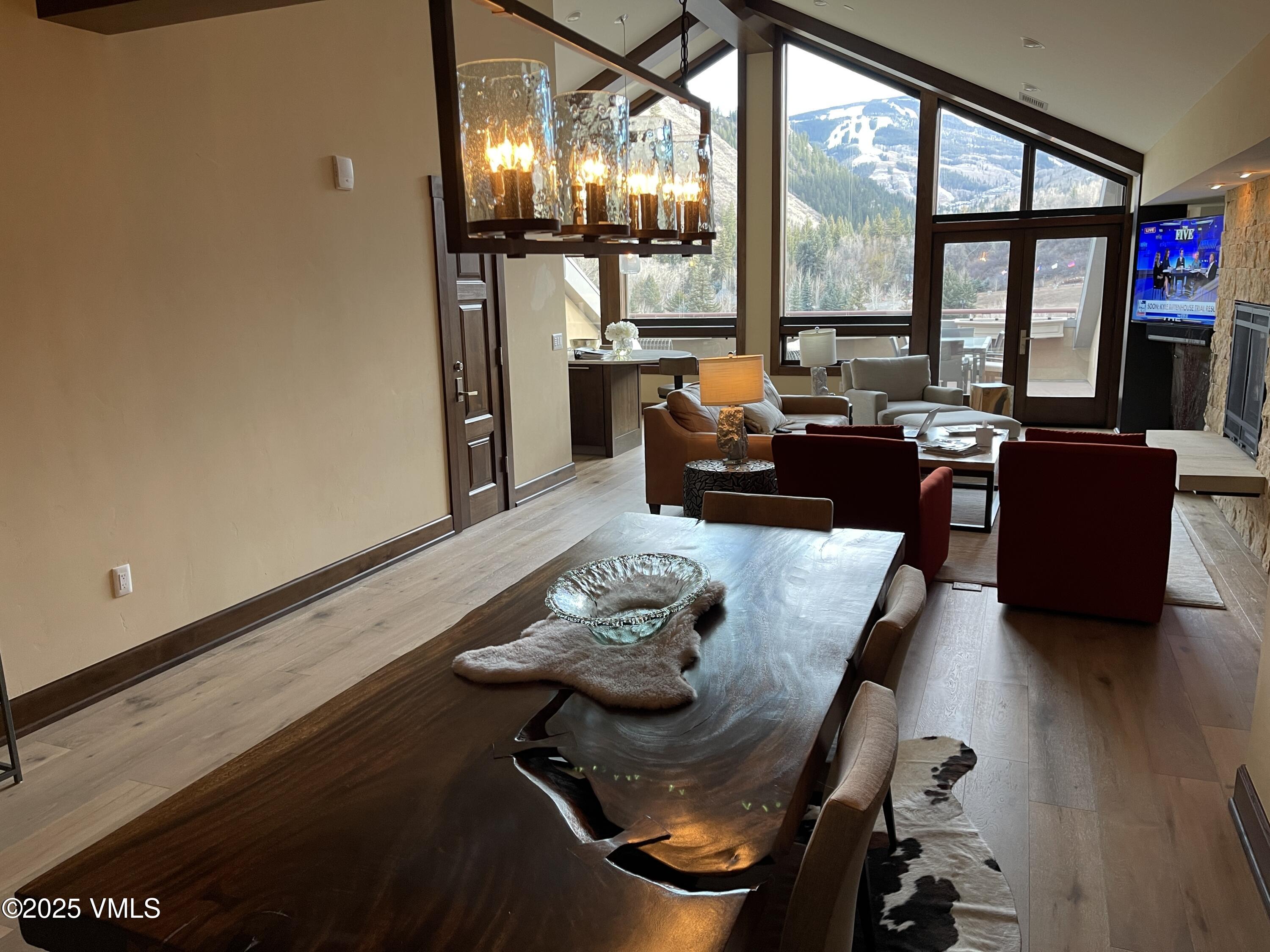 126 Riverfront Lane, Unit 510 Avon, CO 81620 - Photo 11 of 54 a living room with furniture and a floor to ceiling window