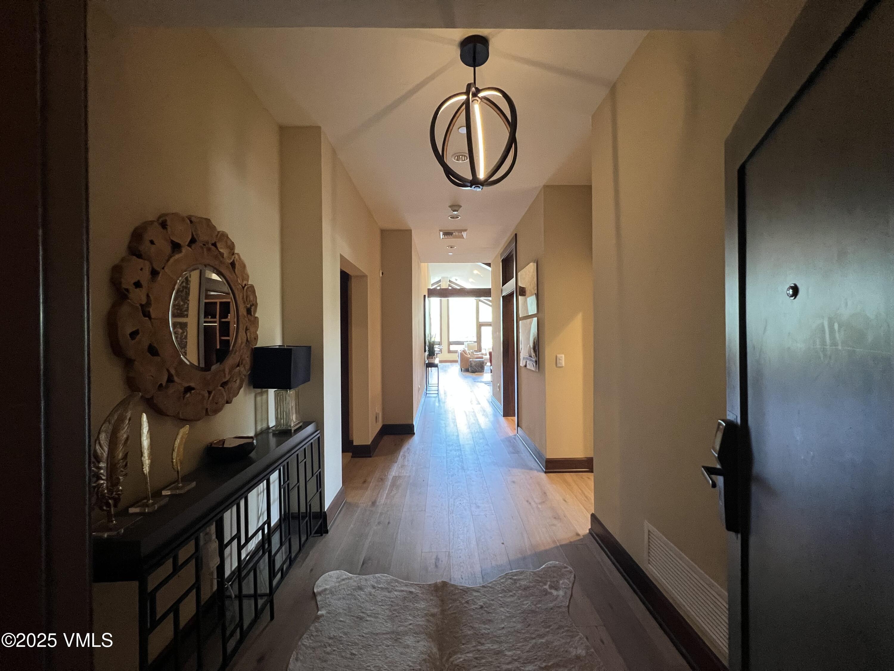 126 Riverfront Lane, Unit 510 Avon, CO 81620 - Photo 2 of 54 a view of a hallway with wooden floor