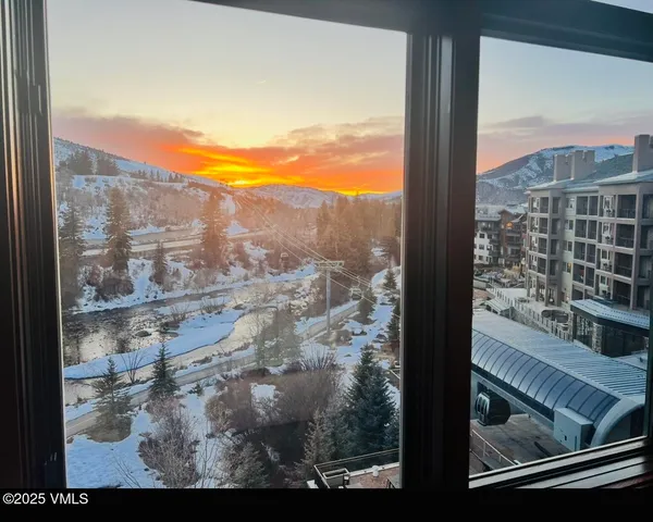 a view of a hallway with furniture and front door