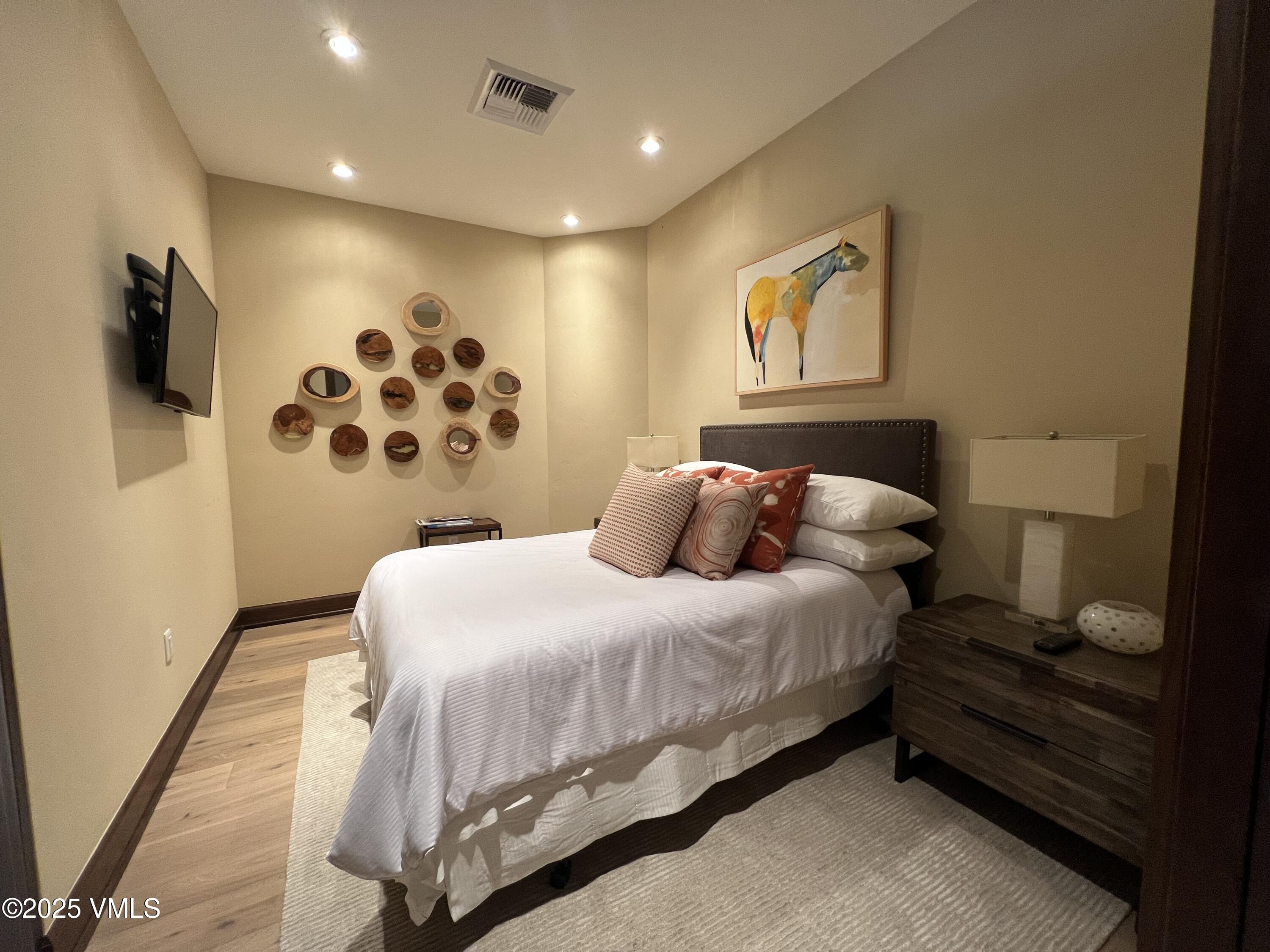 126 Riverfront Lane, Unit 510 Avon, CO 81620 - Photo 37 of 54 a bedroom with bed and a flat screen tv