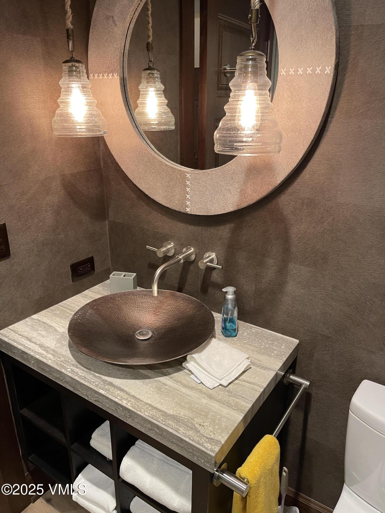 126 Riverfront Lane, Unit 510 Avon, CO 81620 - Photo 38 of 54 a bathroom with a granite countertop sink and a mirror