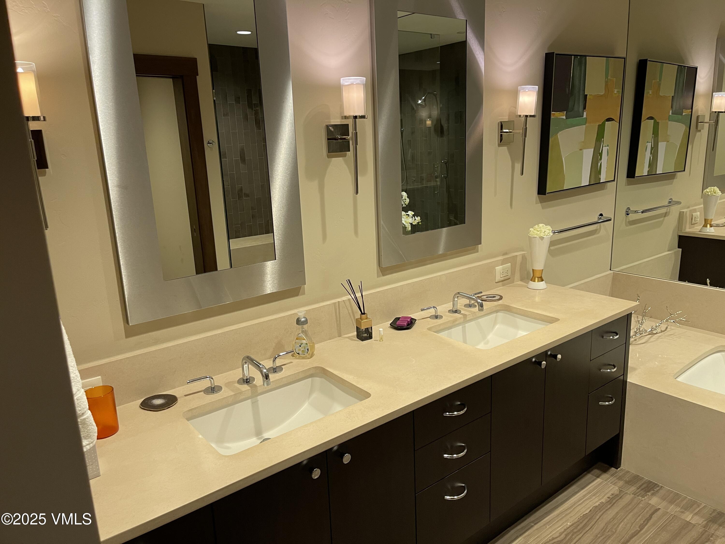 126 Riverfront Lane, Unit 510 Avon, CO 81620 - Photo 45 of 54 a bathroom with a double vanity sink and mirror