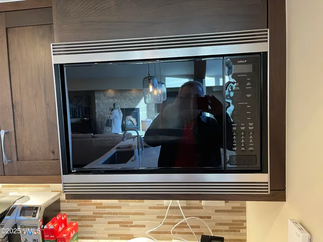 a bedroom with a bed couch and large window