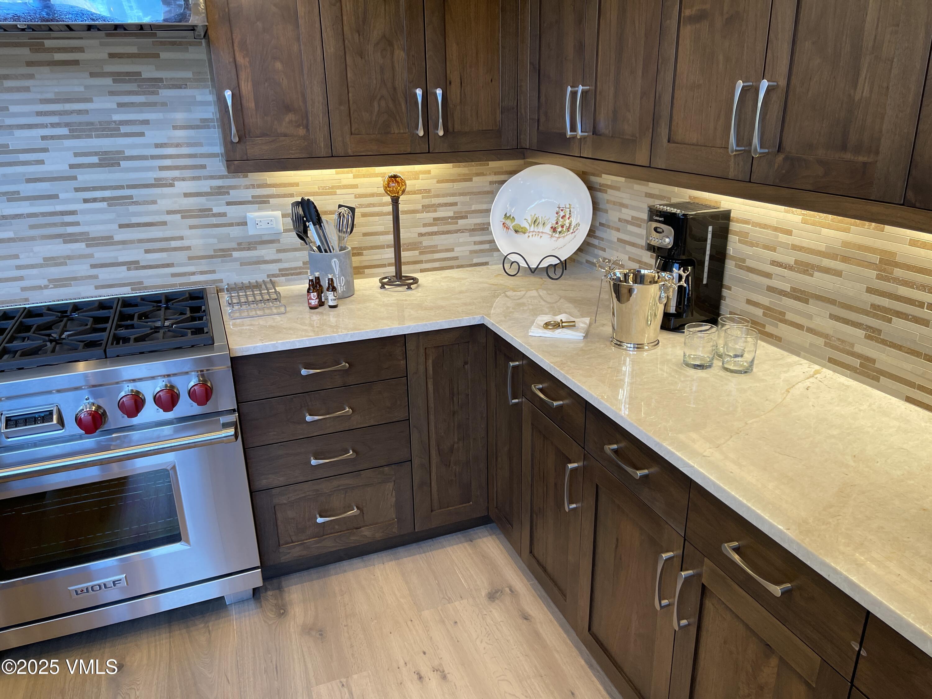 126 Riverfront Lane, Unit 510 Avon, CO 81620 - Photo 10 of 54 a kitchen with stainless steel appliances granite countertop a sink a stove and cabinets