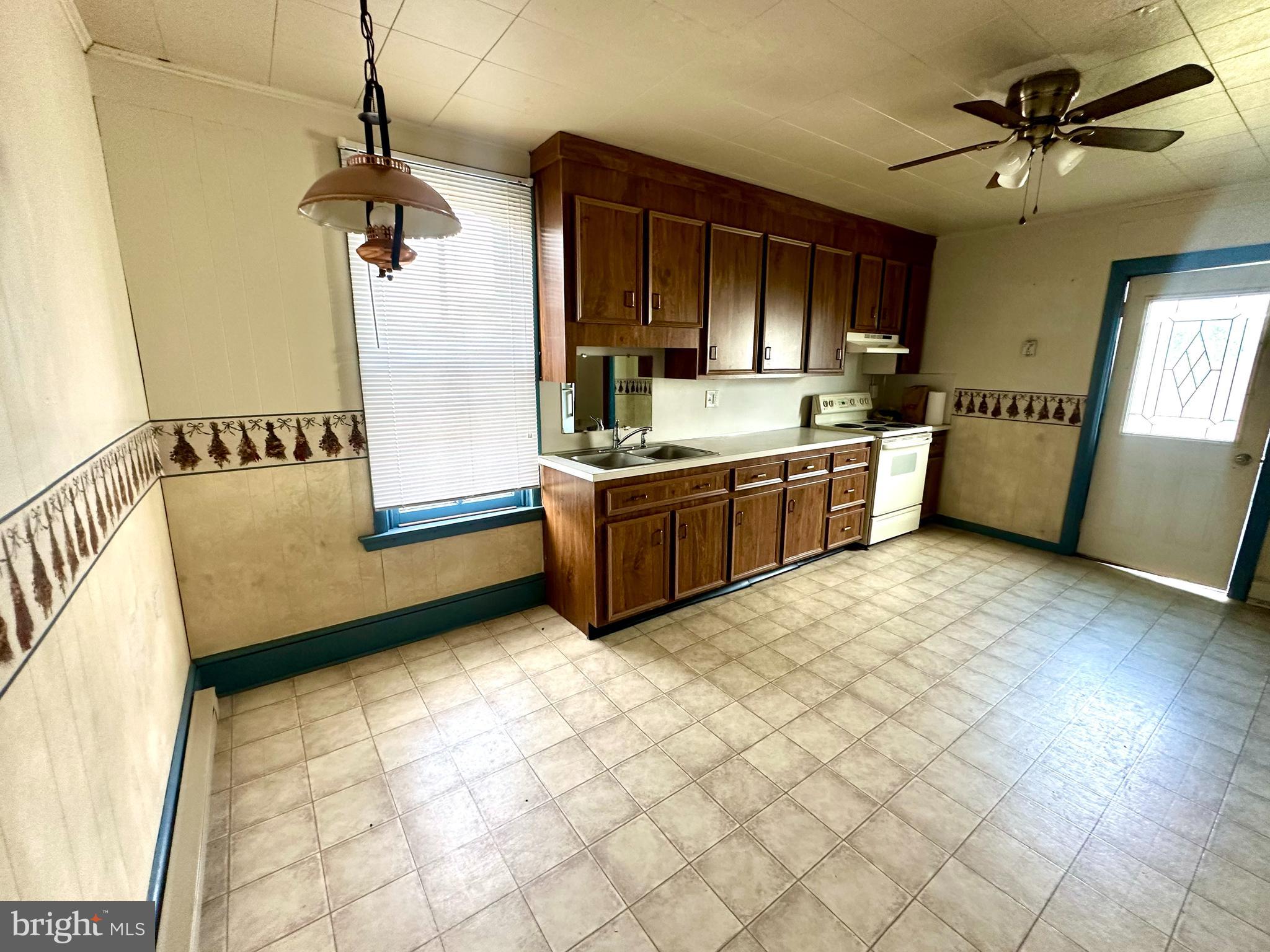 4576 Lemar Road, Unit 3 Mercersburg, PA 17236 - Photo 13 of 15 a kitchen with stainless steel appliances a sink a stove a refrigerator and cabinets