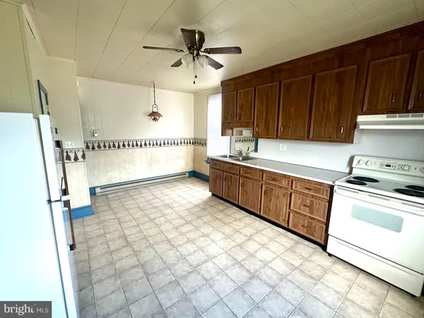 a kitchen with stainless steel appliances a stove a refrigerator and cabinets
