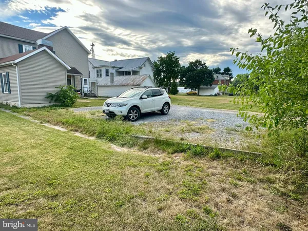 a view of car parked in front of house with yard