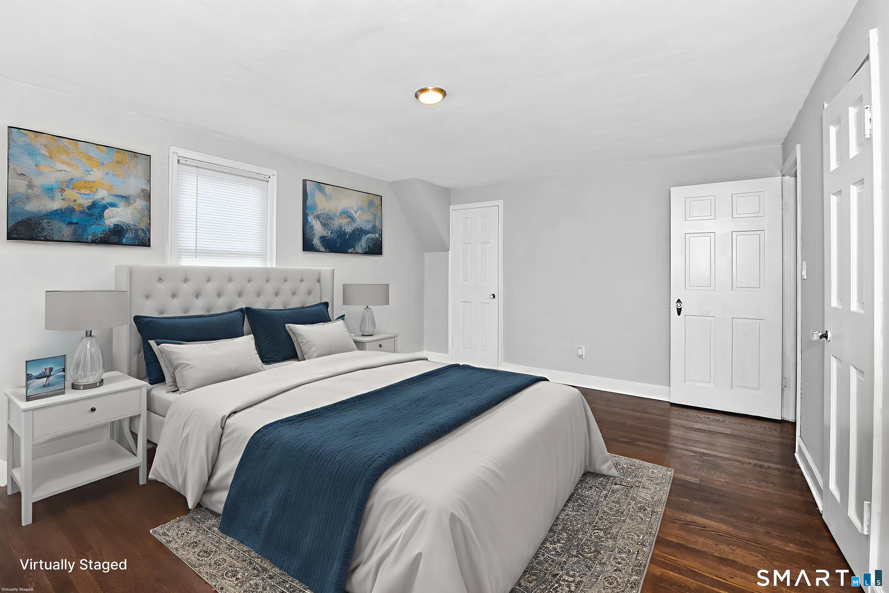 63 Park Road Hamden, CT 06517 - Photo 22 of 39 a bedroom with a bed and a painting on the wall