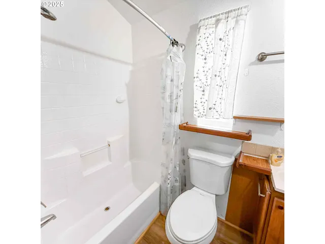 a white toilet sitting next to a bath tub shower