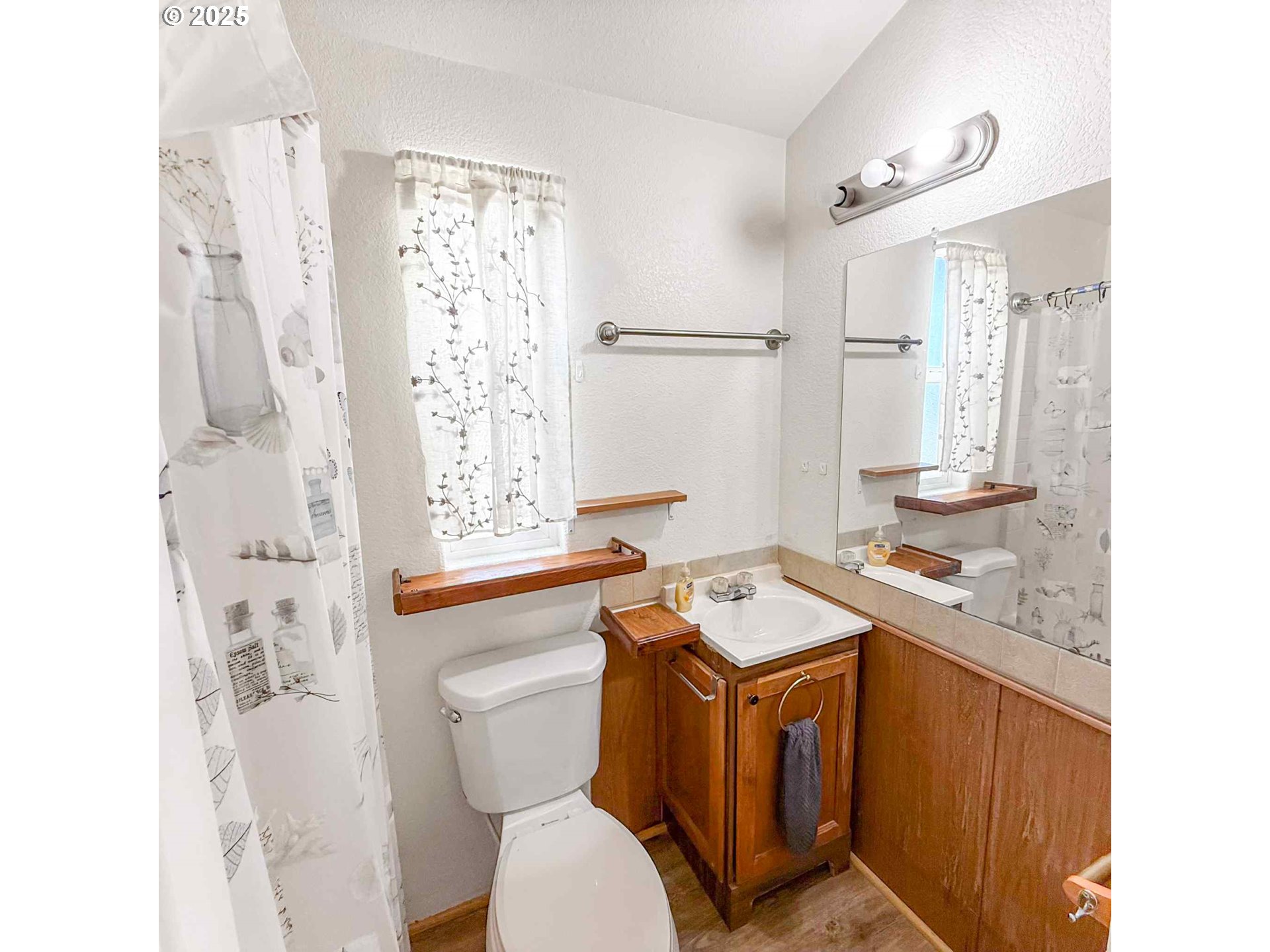 15061 Highway 101, Unit 4 Brookings, OR 97415 - Photo 14 of 19 a bathroom with a sink toilet vanity and shower