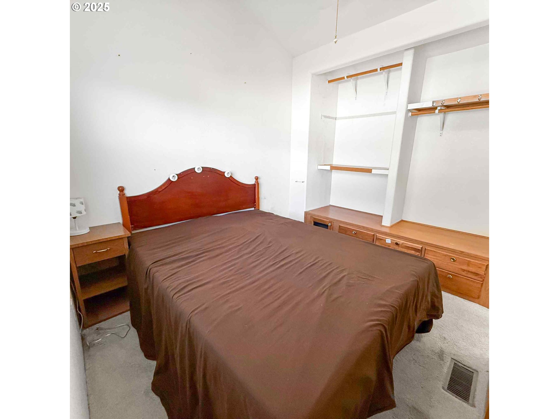 15061 Highway 101, Unit 4 Brookings, OR 97415 - Photo 15 of 19 a bedroom with a bed and a cabinets