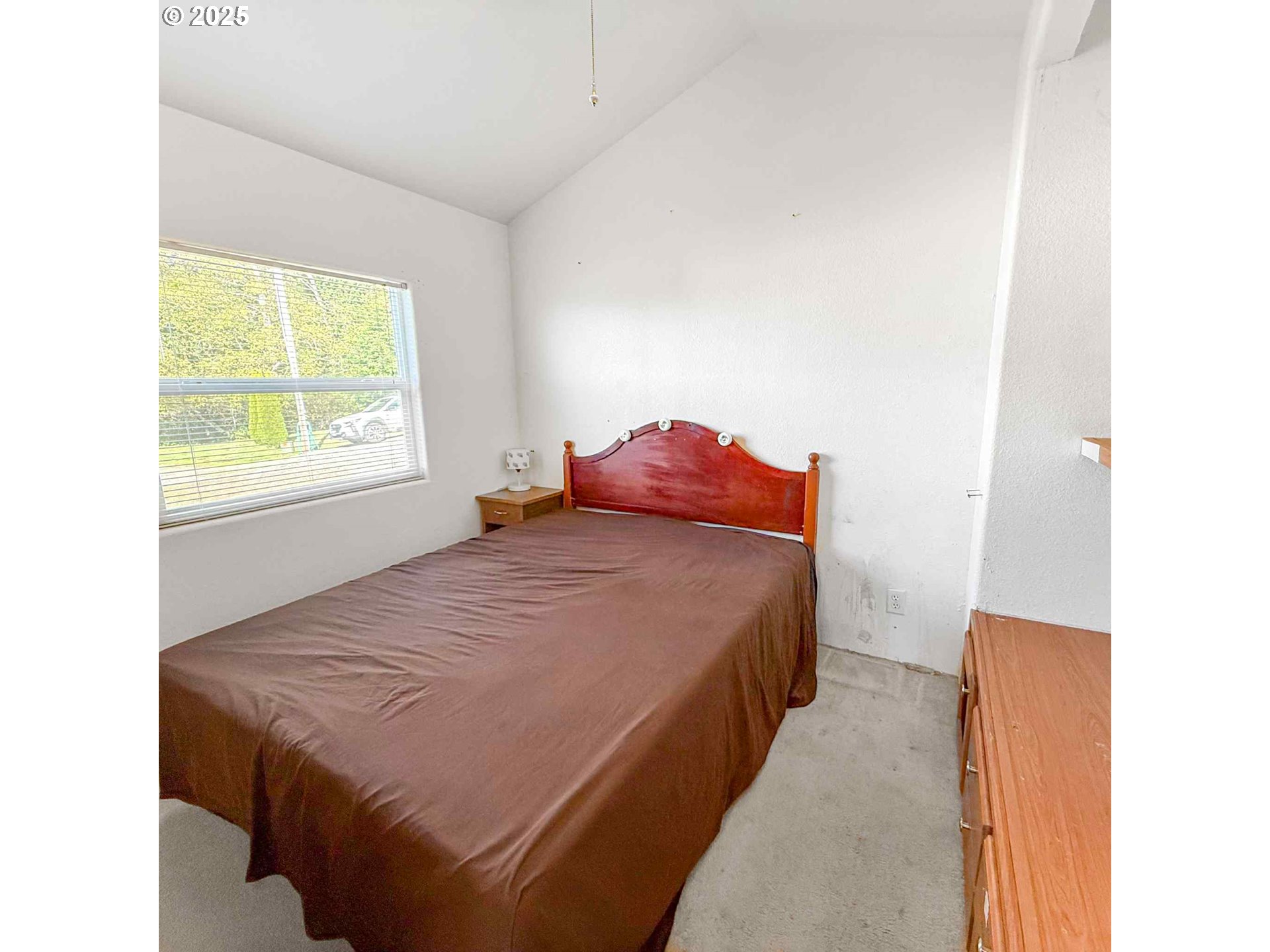 15061 Highway 101, Unit 4 Brookings, OR 97415 - Photo 16 of 19 a bed sitting in a bedroom next to a window